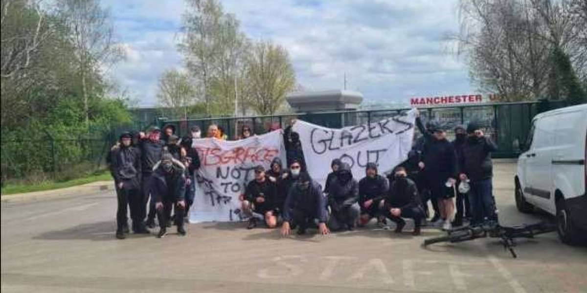 (photo): Manchester United supporters demonstrate outside Carrington Stadium with anti-Glazer placards.